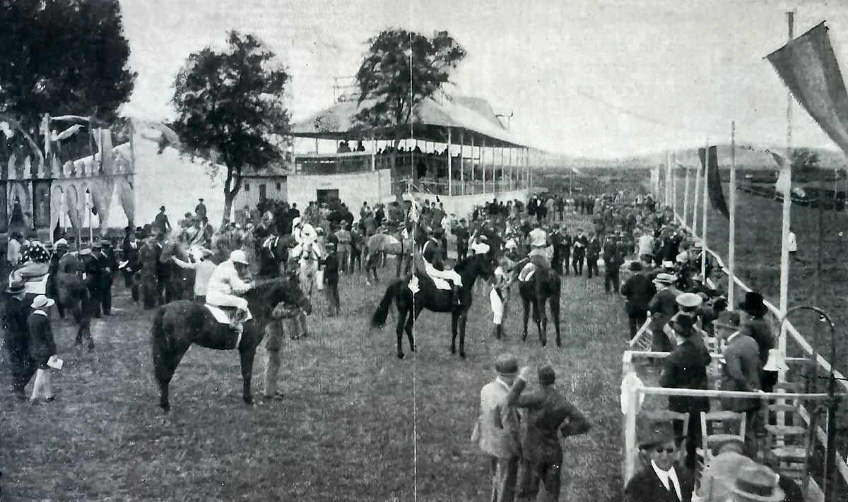 A race day of the Real Jockey Club de Jerez: riders and horses in front of the racecourse grandstand